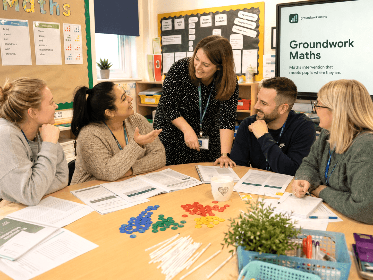A group of teachers collaborating around Groundwork Maths materials.